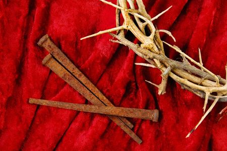 Crown of Thorns with metal spikes on red background.の写真素材