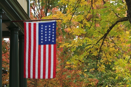 American Flag hanging in the autumn seasonの写真素材