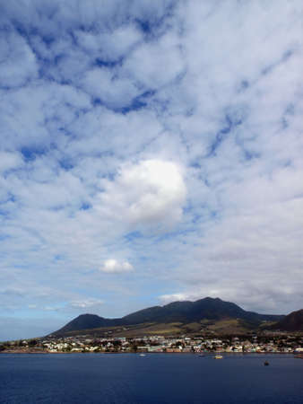 View of St. Kitts under cloudy blue skyの写真素材