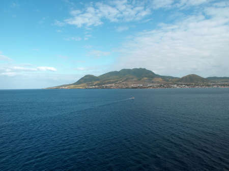 View of St. Kitts under cloudy blue skyの写真素材