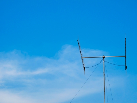 metal tv antenna on blue sky backgrounds for businessの写真素材