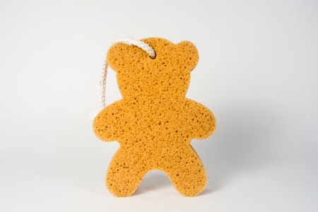 yellow bear of sponge bath isolated on white backgroundsの写真素材
