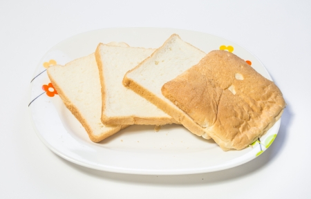 bread cutting on dish isolated on white backgrounds