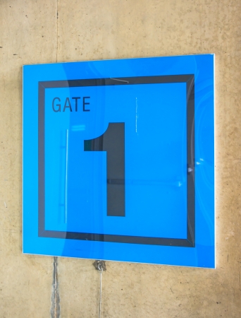 blue sign symbol of gate one of stadium on wallの写真素材