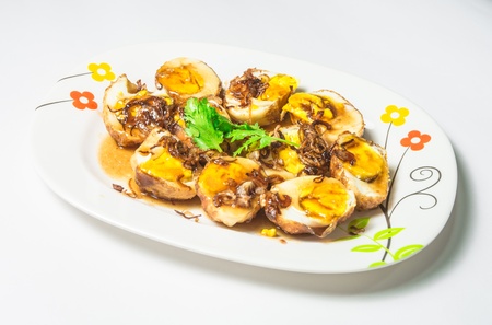 akelokek food  eeg asia style on dish isolated on white backgroundsの写真素材