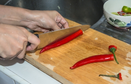 young hand women cooking about red Paprika pepper on kitchenの写真素材