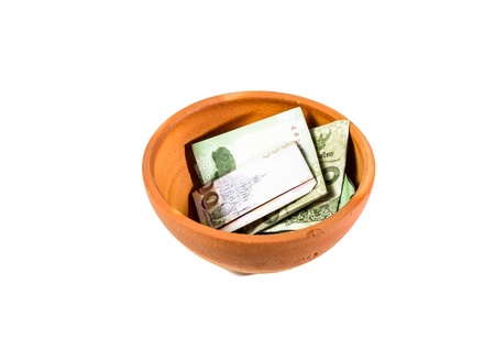 thailand money in small brown bake clay bowl isolated