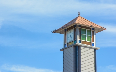 old wooden clock tower on sky at natural parkの写真素材