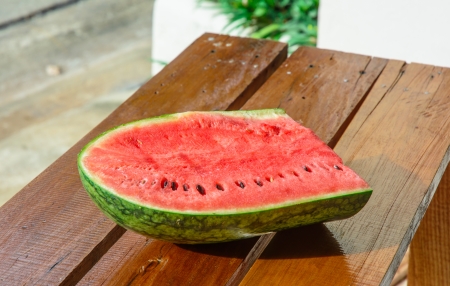 single watermelon cut on wood table at natural backgroundの写真素材