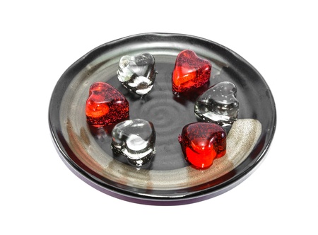many heart shape of ice on black dish isolated on white backgroundの写真素材