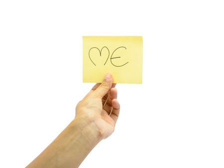 young hand hold some word on yellow  paper isolated on white packgroundの写真素材