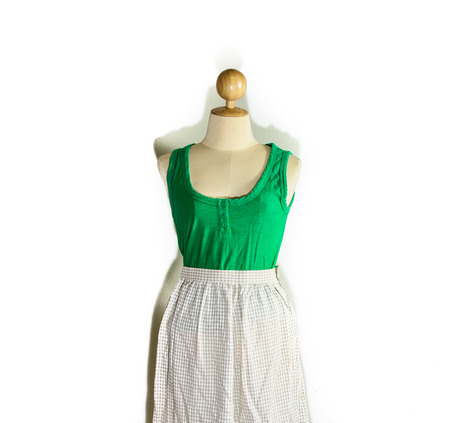 general lady green vest and grey color long dress at dummy shirt with shadow isolated on white backgroundの写真素材