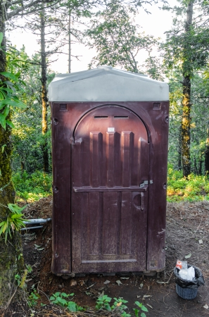 Small plastic outdoors toilet in winter season nature at mountain backgroundの写真素材