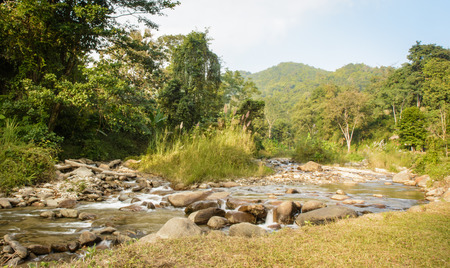 small waterfall river at outdoor sunset on natural hill thailandの写真素材
