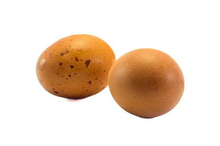 two chicken eggs and glass isolated on white background