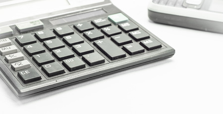 Black Calculator and mobile phone on white backgroundの写真素材