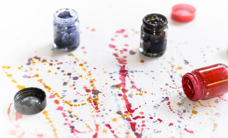 Colorful water color splash with color bottle on paper background