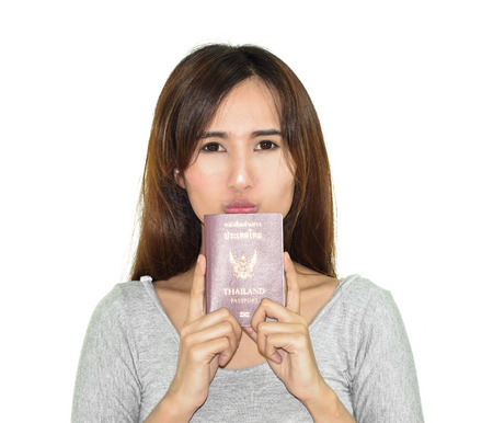Happy asia young woman holding thailand passport isolated on white backgroundの写真素材