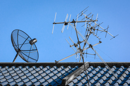 Satellite Dishes with old television radar metal on roof building for telecommunication