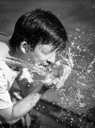 asia young man washing him face and Water splash.の写真素材
