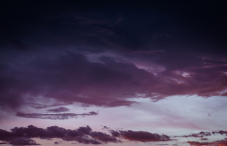 beauty evening sunset with dark blue and red clouds for backgroundの写真素材