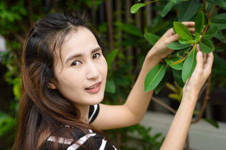 asia cute girl in the garden of natural tree at outdoor sunriseの写真素材