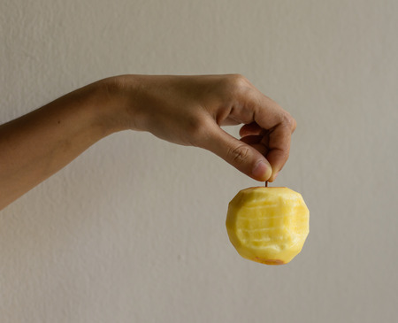 girl hand hold Red apple on old concrete wall の写真素材