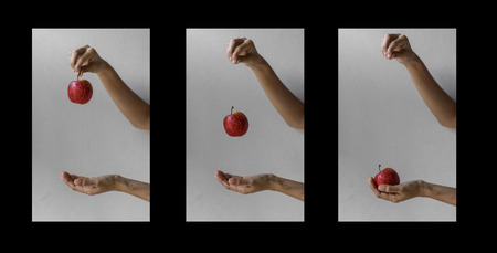 girl hand throw an apple with three camera shoot on concrete wall