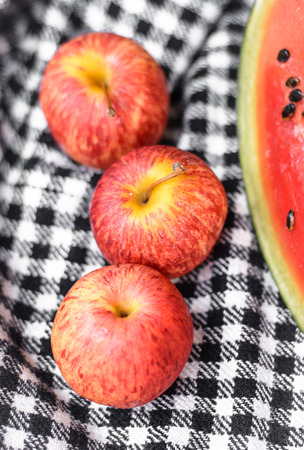 fruit red apples and watermelon on plaid fabric pattern の写真素材