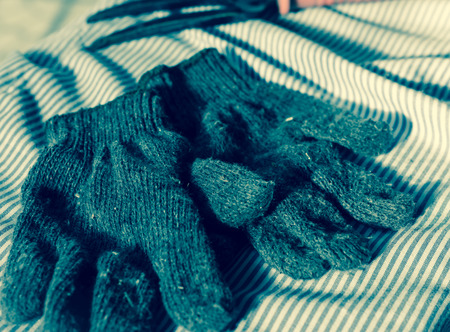 old Cotton gloves gardening with retro filter on fabric pattern at sunriseの写真素材