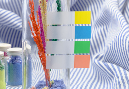 vintage decoration glass bottle, with color paper blank label  on fabric pattern backgroundの写真素材