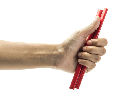 girl hand holding red pencil isolated on white backgroundの写真素材