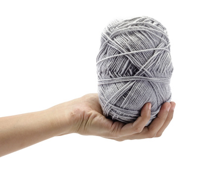 asian woman hand holding grey Knitting roll isolated on white backgroundの写真素材