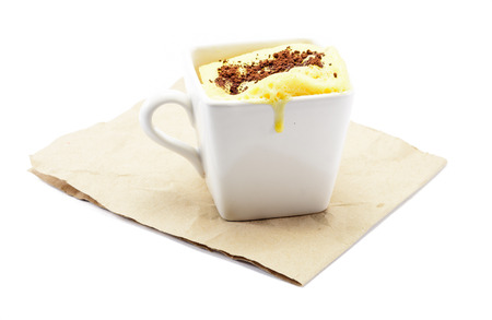 yellow butter cake and cocoa powder at brown paper isolated on white backgroundの写真素材