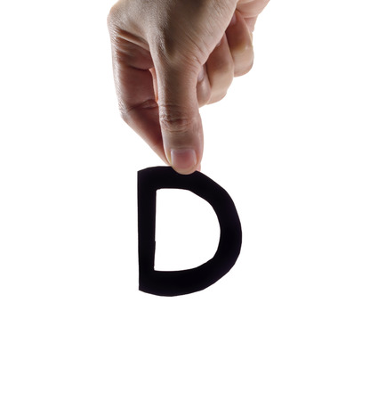 woman hand holding the black letter d, isolated on white backgroundの写真素材