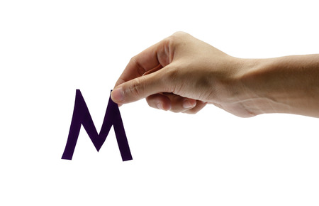 woman right hand holding the old color letter m, isolated on white backgroundの写真素材