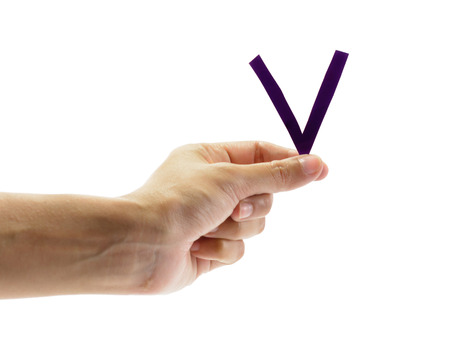 woman hand holding the old letter v, isolated on white background