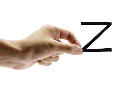 woman hand holding the black letter z, isolated on white backgroundの写真素材