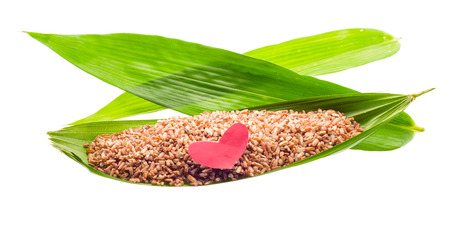 asian Black rice (Berry rice) and heart paper at bamboo leaf isolated on white backgroundの写真素材