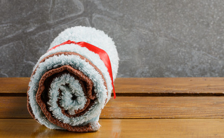 towel blue color on wood table at old metal backgroundの写真素材