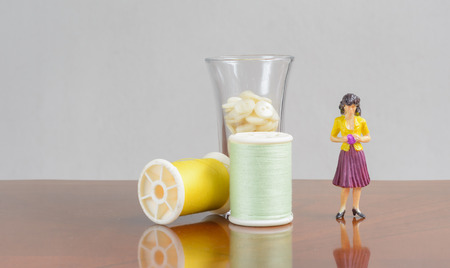 figurine miniature woman people with sewing kit set concept business fashion