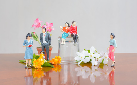 miniature family people with a flower  concept resting day