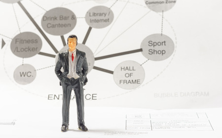 Miniature of businessman with diagram work  concept about sport interior theme