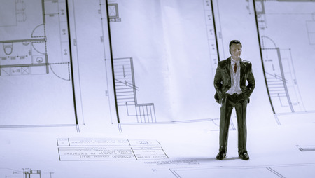 Miniature of businessman concept about work interior plan with retro filter