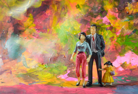 Miniature little family people at color backgroundの写真素材