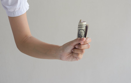 Female hands holding dollar money at wall 