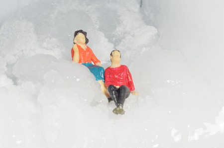 Miniature toy family people with stone ice