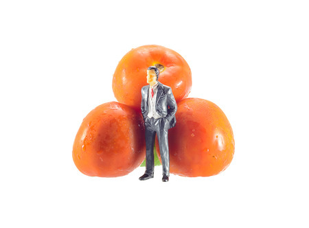 vegetable tomato with concept market businessman miniature  isolated on whiteの写真素材