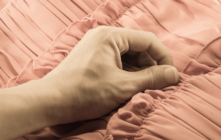man hand touching cotton fabric textile background with retro filter