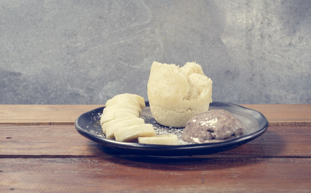 banana cake with chocolate cream on table with retro filterの写真素材